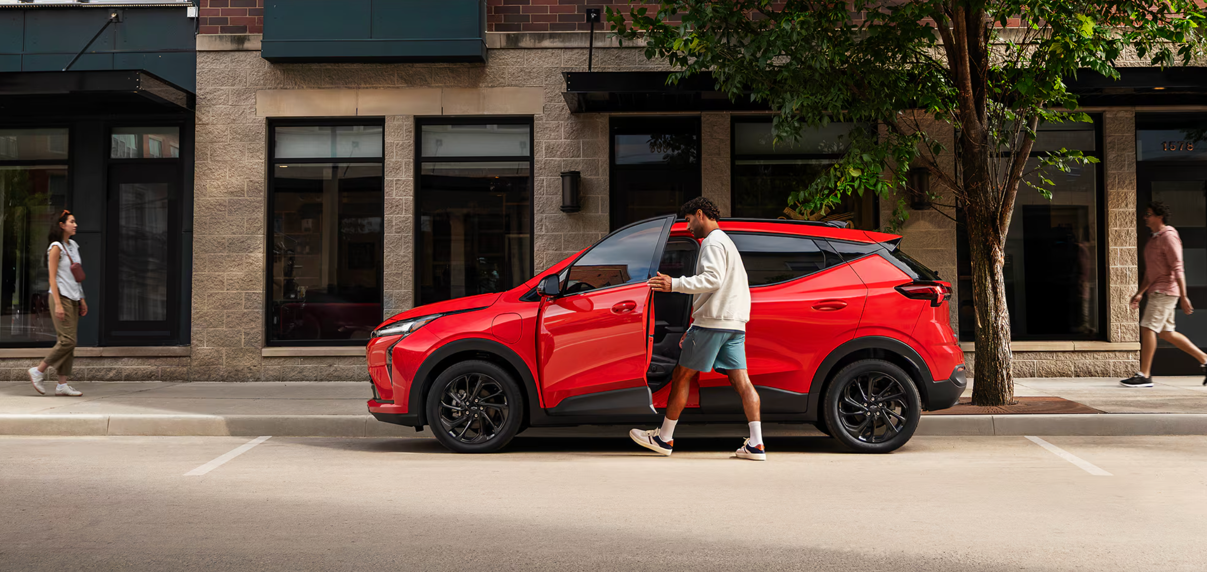 Man entering red 2027 Chevy Bolt near Williamstown